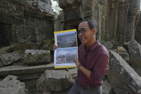 Long Kosal, spokesperson for APSARA, the Cambodian office that oversees the Angkor archaeological site, speaks to the Associated Press inside the Ta Prohm temple at Angkor Wat temple complex in Siem Reap province, Cambodia, Wednesday, April 3, 2024. Cambodian authorities are investigating the abuse of monkeys at the world-famous Angkor UNESCO World Heritage Site. Officials say some YouTubers are physically abusing the macaques to earn cash by generating more views. (AP Photo/Heng Sinith)