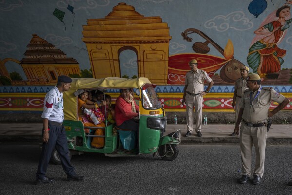 Policemen stop an auto rickshaw at a checkpoint as traffic restrictions and diversions are placed ahead of the weekend's G20 Summit, in New Delhi, India, Friday, Sept. 8, 2023. (AP Photo/Altaf Qadri)