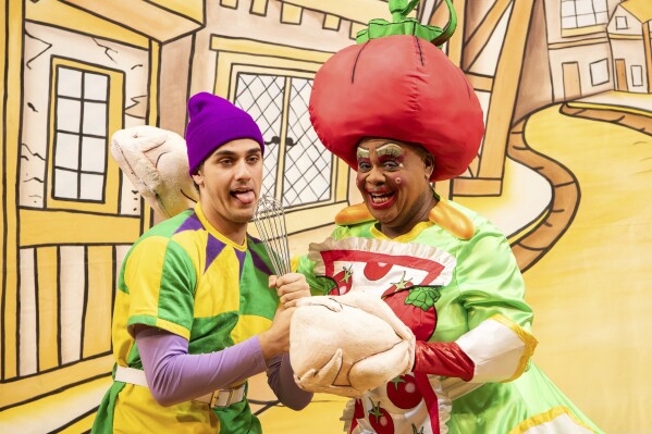 Olivier Award-winner Clive Rowe (right) performs as Dame Sarah the Cook during a photocall for Hackney Empire's Dick Whittington and His Cat in London, Tuesday, Dec. 3, 2024. (AP Photo/Thomas Krych)