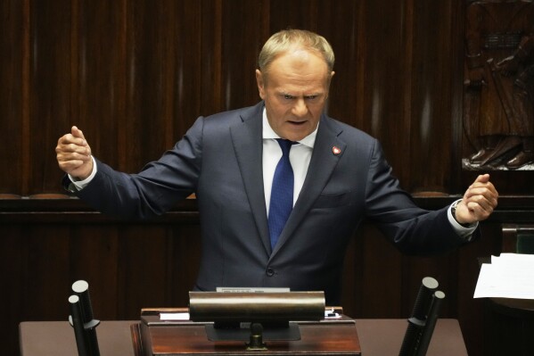Poland's Prime Minister Donald Tusk addresses the Polish parliament on Wednesday, June 11, 2025, in Warsaw, Poland. (AP Photo/Czarek Sokolowski)
