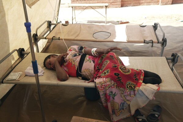 A cholera patient lies on a hospital bed, in Harare, Zimbabwe, Sunday Nov. 19, 2023. A cholera outbreak in Zimbabwe is suspected of killing more than 150 people and infecting more than 8,000. The virulent bacterial disease is striking fear in many in the southern African country who live in impoverished and neglected areas where sanitation conditions are poor and local government failures have left them with no access to clean water. (AP Photo/Tsvangirayi Mukwazhi)