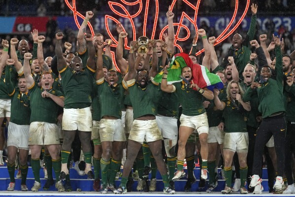 South Africa's Siya Kolisi holds the trophy aloft during presentation ceremony after the Rugby World Cup final match between New Zealand and South Africa at the Stade de France in Saint-Denis, near Paris Saturday, Oct. 28, 2023. South Africa won the match 12-11. (AP Photo/Thibault Camus)