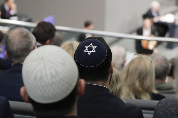 
              In this Thursday, Jan. 31, 2019, file photo, two men wearing skullcaps as they listen to the speech of Israeli Historian Saul Friedlaender, during a remembrance event of the parliament Bundestag to commemorate the victims of the Holocaust at the Reichstag building in Berlin. Israeli President Reuven Rivlin said Sunday he is shocked by a statement by Felix Klein, the government's anti-Semitism commissioner, that he wouldn't advise Jews to wear skullcaps in parts of the country for their safety. (AP Photo/Markus Schreiber)
            