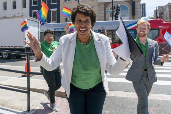 District of Columbia Mayor Muriel Bowser, center, arrives for a news conference ahead of DC Pride events, Friday, June 10, 2022, in Washington. At right is Japer Bowles, director of the Mayor's Office of Lesbian, Gay, Bisexual, Transgender and Questioning Affairs. Bowser is seeking a third term in office. Bowser is facing a formidable fight for a third term. Her challengers in Tuesday's Democratic primary include two council members who have criticized her response to spiraling violent crime rates in the district. (AP Photo/Jacquelyn Martin)
