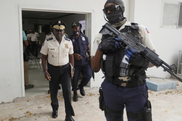 FILE - Leon Charles, left, Director General of Haiti's Police leaves a room after a news conference at police headquarters in Port-au-Prince, Wednesday, July 14, 2021. Charles gave an update on the investigation of the July 7 assassination of President Jovenel Moise. A judge investigating the July 2021 assassination of President Moïse issued a final report on Monday, Feb. 19, 2024, that indicts his widow, Martine Moïse, ex-prime minister Claude Joseph and the former chief of Haiti’s National Police, Charles, among others. (AP Photo/Fernando Llano, File)
