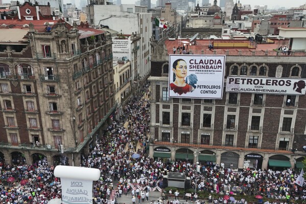Supporters of ruling party presidential candidate Claudia Sheinbaum arrive at the Zocalo for her closing campaign rally in Mexico City, Wednesday, May 29, 2024, on the last day of campaigning ahead of the June 2 general election. (AP Photo/Matias Delacroix)