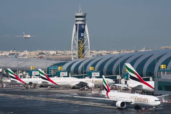 An Emirates jetliner comes in for landing at the Dubai International Airport in Dubai, United Arab Emirates, Dec. 11, 2019. (AP Photo/Jon Gambrell, File)