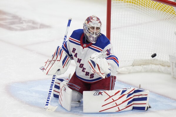 New York Rangers goaltender Igor Shesterkin looks back as a puck hit by Florida Panthers center Sam Reinhart gets past him to score during an overtime period of Game 4 during the Eastern Conference finals of the NHL hockey Stanley Cup playoffs, Tuesday, May 28, 2024, in Sunrise, Fla. (AP Photo/Wilfredo Lee)