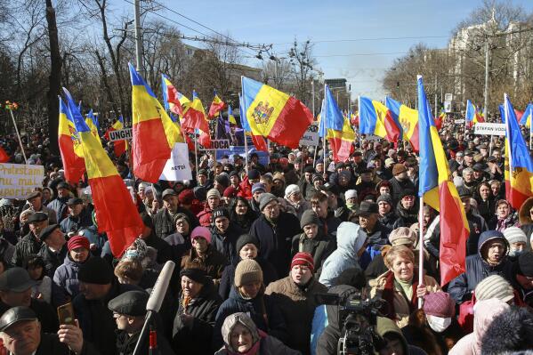 People wave flags during a protest initiated by the Movement for the People and members of Moldova's Russia-friendly Shor Party, against the pro-Western government and low living standards, in Chisinau, Moldova, Sunday, March 12, 2023. Moldovan police said on Sunday they have foiled a plot by groups of Russia-backed actors who were specially trained to cause mass unrest during a protest the same day in the capital against the country's new pro-Western government. (AP Photo/Aurel Obreja)