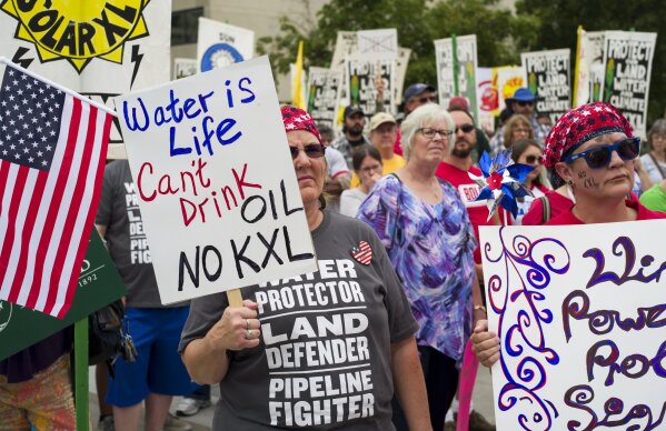 
              FILE - In this Aug. 6, 2017 file photo, demonstrators against the Keystone XL pipeline listen to speakers in Lincoln, Neb. Eager to jump-start the stalled Keystone XL oil pipeline and other energy projects, President Donald Trump has moved to assert presidential power over pipelines and other infrastructure. (AP Photo/Nati Harnik, File)
            