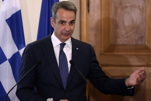FILE - Greek Prime Minister Kyriakos Mitsotakis addresses the media at the Presidential Palace in Nicosia, Cyprus, on Monday, July 31, 2023. Torrential rain sweeping across central Greece has damaged roads, flooded homes and caused power outages on the island of Evia. “I will restate the obvious: The frequency of (weather) assaults due to the climate crisis is something that requires us to integrate civil protection (in our response),” Prime Minister Kyriakos Mitsotakis told a Cabinet meeting Wednesday, Sept. 27. (Yiannis Kourtoglou Pool via AP)