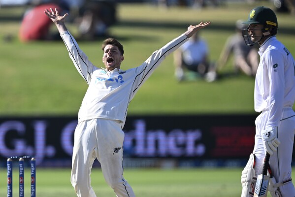 New Zealand's Mitch Santner appeals successfully for a LBW decision to dismiss South Africa's Tshepo Moreki as Ruan de Swardt, right, watches, on day four of the first cricket test between New Zealand and South Africa at Bay Oval, Mt Maunganui, New Zealand, Wednesday, Feb. 7, 2024. (Photo: Andrew Cornaga/Photosport via AP)