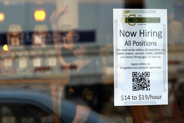FILE - A sign advertises for help The Goldenrod, a popular restaurant and candy shop, Wednesday, June 1, 2022, in York Beach, Maine. America’s hiring boom continued in July as employers added a surprising 528,000 jobs despite raging inflation and rising anxiety about a recession.  (AP Photo/Robert F. Bukaty)