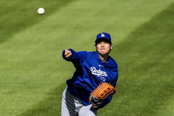 Los Angeles Dodgers' Shohei Ohtani throws before a baseball game against the Washington Nationals at Nationals Park, Tuesday, April 23, 2024, in Washington. (AP Photo/Alex Brandon)
