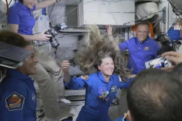 In this image from video made available by NASA, Russian Cosmonaut Anna Kikina enters the International Space Station from a SpaceX Crew Dragon capsule on Thursday, Oct. 6, 2022. Kikina is the first Russian to launch from the U.S., in 20 years. (NASA via AP)