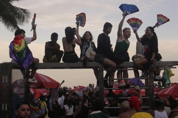 Fans cheer as they wait for the start of Lady Gaga's free concert on Copacabana beach in Rio de Janeiro, Saturday, May 3, 2025. (AP Photo/Bruna Prado)
