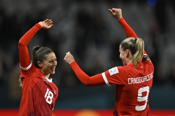 Switzerland's Ana Maria Crnogorcevic, right, celebrates with Switzerland's Viola Calligaris after the Women's World Cup Group A soccer match between New Zealand and Switzerland in Dunedin, New Zealand, Sunday, July 30, 2023. (AP Photo/Andrew Cornaga)