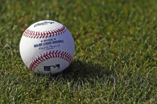FILE - In this Feb. 17, 2017, file photo, a baseball is shown on the grass at the Cincinnati Reds baseball spring training facility in Goodyear, Ariz. Major League Baseball rejected the players' offer for a 114-game regular season in the pandemic-delayed season with no additional salary cuts and told the union it did not plan to make a counterproposal, a person familiar with the negotiations told The Associated Press. The person spoke on condition of anonymity Wednesday, June 3, 2020, because no statements were authorized. (AP Photo/Ross D. Franklin, FIle)