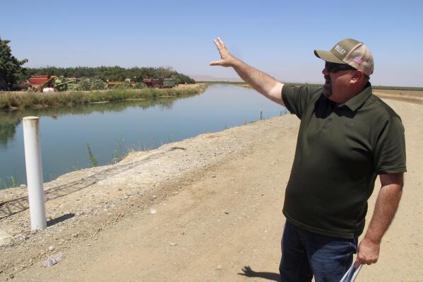 Kevin Spesert, public affairs and real estate manager for the Sites Project Authority, points out the main canal of the Glenn Colusa Irrigation District, on Friday, July 23, 2021, near Sites, Calif. The canal would be one of the primary sources of water for the planned Sites Reservoir, a project that would be large enough to supply enough water for 1.5 million households each for one year.(AP Photo/Adam Beam)