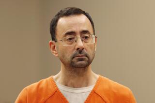 FILE - In this Nov. 22, 2017, file photo, Dr. Larry Nassar, appears in court for a plea hearing in Lansing, Mich. The $490 million settlement announced Wednesday, Jan. 19, 2022 by the University of Michigan is just $10 million shy of the $500 million Michigan State University agreed in 2018 to pay to sexual assault victims of its own sport doctor, Larry Nassar. (AP Photo/Paul Sancya, File)