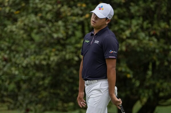 CORRECTS SPELLING OF NAME TO SI, NOT IS - Si Woo Kim, of South Korea, reacts to a missed putt on the 10th green during the second round of the Masters golf tournament on Friday, April 9, 2021, in Augusta, Ga. (AP Photo/Gregory Bull)