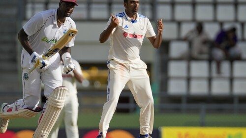 India's Ravichandran Ashwin reacts with West Indies' Jason Holder as they bowl on day three of their first cricket Test match at Windsor Park in Roseau, Dominica, Friday, July 14, 2023.  (AP Photo/Ricardo Mazalan)