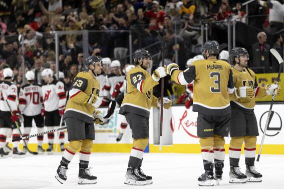 Vegas Golden Knights defenseman Shea Theodore (27) bumps fists with defenseman Brayden McNabb (3) after scoring in the shootout of the team's NHL hockey game against the New Jersey Devils on Friday, March 3, 2023, in Las Vegas. (AP Photo/Ellen Schmidt)
