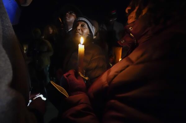 RowVaughn Wells, mother of Tyre Nichols, who died after being beaten by Memphis police officers, smiles to supporters, at the conclusion of a candlelight vigil for Tyre, in Memphis, Tenn., Thursday, Jan. 26, 2023. (AP Photo/Gerald Herbert)