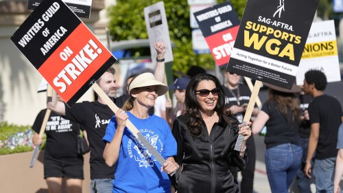 FILE - Meredith Stiehm, left, president of Writers Guild of America West, and Fran Drescher, president of SAG-AFTRA, take part in a rally by striking writers outside Paramount Pictures studio in Los Angeles on May 8, 2023. Hollywood actors may be on the verge of joining screenwriters in what would be the first two-union strike in the industry in more than six decades. (AP Photo/Chris Pizzello, File)