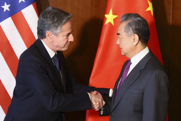 U.S. Secretary of State Antony Blinken, left, and Chinese Foreign Minister Wang Yi shake hands during their meeting at the Munich Security Conference, in Munich, Germany, Friday, Feb. 16, 2024. (Wolfgang Rattay/Pool Photo via AP)