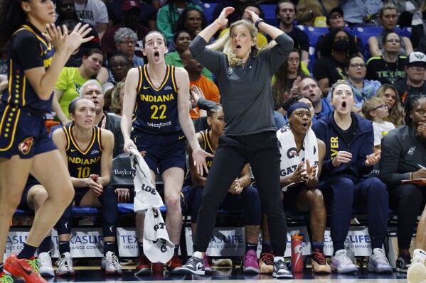 Indiana Fever guard Caitlin Clark (22) and head coach Christine Sides, center right, react after a play during the second half of an WNBA basketball game against the Dallas Wings in Arlington, Texas, Friday, May 3, 2024. (AP Photo/Michael Ainsworth)