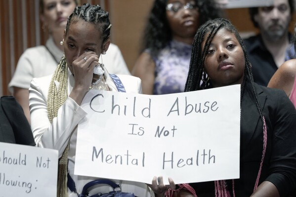  Victims are emotional during a news conference with survivors of abused and neglected youth at residential treatment facilities (RTFs) and advocates, on the need for Congress to act to protect children and reform RTFs, Wednesday, June 12, 2024, on Capitol Hill in Washington. (AP Photo/Mariam Zuhaib)