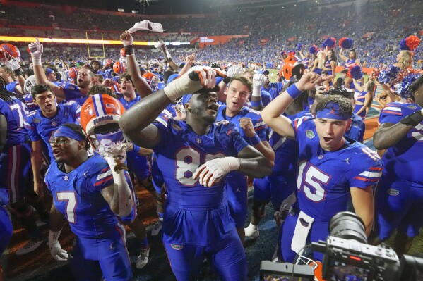 Florida players including Trevor Etienne (7), Caleb Banks (88) and Graham Mertz (15) celebrate after defeating Tennessee in an NCAA college football game, Saturday, Sept. 16, 2023, in Gainesville, Fla. (AP Photo/John Raoux)