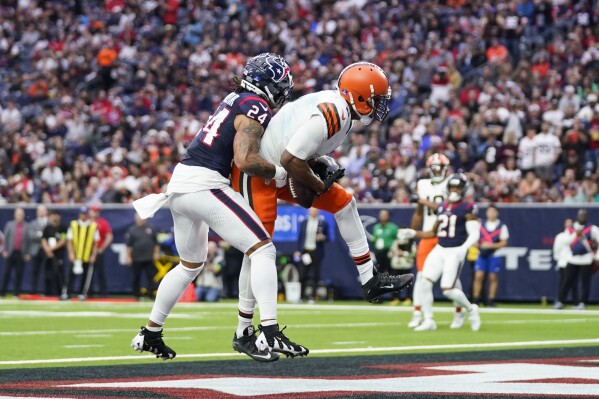Cleveland Browns wide receiver Amari Cooper (2) catches a pass for a touchdown as Houston Texans cornerback Derek Stingley Jr. (24) defends during the second half of an NFL football game Sunday, Dec. 24, 2023, in Houston. (AP Photo/Eric Christian Smith)
