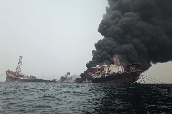 This image from video provided by Bolaji John shows the burning Trinity Spirit anchored 15 miles off the coast of Nigeria, which caught fire on Feb. 2, 2022. The ship had no insurance, no flag, and had fallen into a state of disrepair. Five workers were killed and two others left unaccounted for in the blast. (Bolaji John via AP)