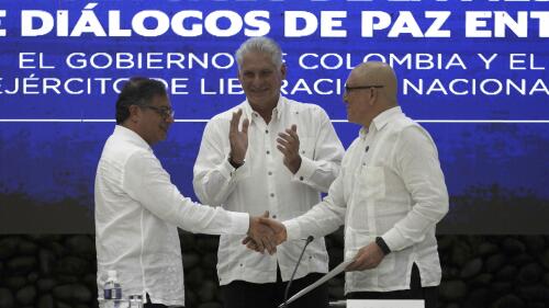 Cuban President Miguel Diaz-Canel applauds as Colombia's President Gustavo Petro, left, and ELN commander Antonio Garcia shake hands during a bilateral ceasefire agreement signing ceremony between Petro's government and the Colombian National Liberation Army (ELN) guerrilla, at El Laguito in Havana, Cuba, Friday, June 9, 2023. (AP Photo/Ramon Espinosa)