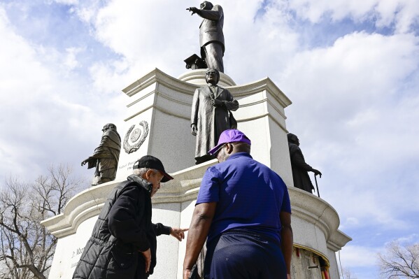 FILE - Sculptor Ed Dwight, left, and Dr. Vern Howard, chairman of the Dr. Martin Luther King Jr. Colorado Holiday Commission, discuss the vandalism to the Dr. Martin Luther King Jr. monument in City Park, Feb. 21, 2024, in Denver. Dwight designed the monument while Howard was the project manager. Three bronze artworks stolen from the Dr. Martin Luther King Jr. memorial, along with seven bronze pieces taken from a nearby fountain, were recovered after being sold to a scrap metal business, Denver Police said Tuesday, Feb. 27. (Andy Cross/The Denver Post via AP, File)