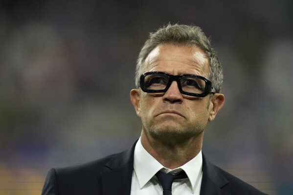 FILE - France's head coach Fabien Galthie walks on the pitch as his players warm-up before the Rugby World Cup quarterfinal match between France and South Africa at the Stade de France in Saint-Denis, near Paris on Oct. 15, 2023. Winning the Six Nations championship may at least go some way to erasing the pain of Rugby World Cup frustration for both France and Ireland. Whoever wins their opening-game showdown in Marseille on Friday Feb. 2, 2024 will have taken a big step toward it, given that the winner of the home game between the sides in the past two years has won the tournament and done the Grand Slam. (AP Photo/Thibault Camus, File)