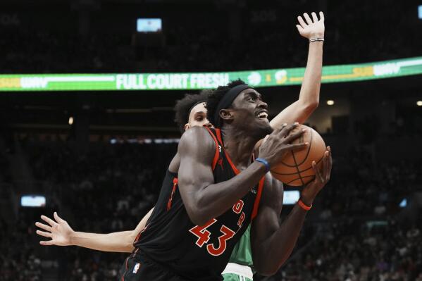 Toronto Raptors' Pascal Siakam (43) drives past Boston Celtics' Derrick White during the first half of an NBA basketball game in Toronto, Monday, Dec. 5, 2022. (Chris Young/The Canadian Press via AP)