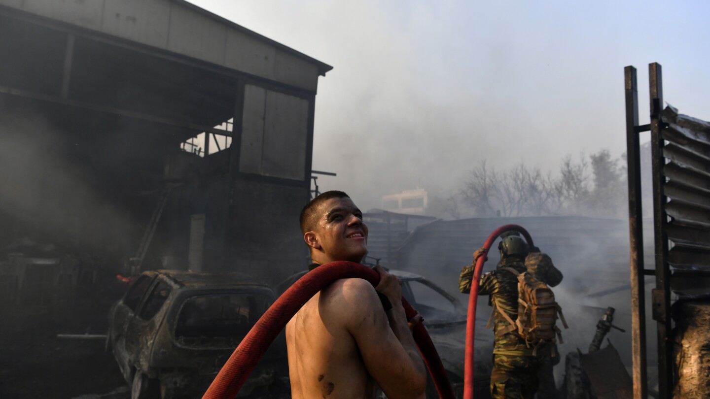 Lower winds give hope to firefighters battling massive wildfires on Athens outskirts. One person killed