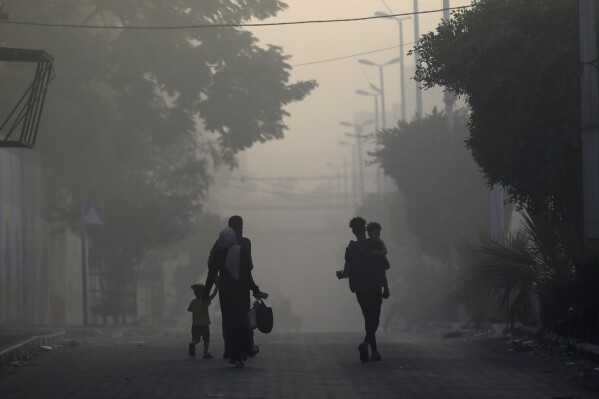 Palestinians flee the Naser neighborhood following Israeli airstrike on Gaza City, Wednesday, Nov. 8, 2023. (AP Photo/Abed Khaled)