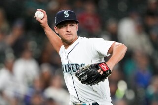 FILE -Seattle Mariners relief pitcher Trevor Gott makes a throw to first base during a baseball game against the Washington Nationals, Tuesday, June 27, 2023, in Seattle. Right-handed reliever Trevor Gott has reached agreement on a $1.5 million, one-year contract with the Oakland Athletics. The team announced the deal Tuesday, Dec. 19, 2023 that brings the experienced pitcher back to the Bay Area where he once was closer for the San Francisco Giants.(AP Photo/Lindsey Wasson, File)