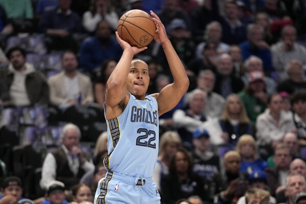 Memphis Grizzlies guard Desmond Bane (22) shoots and sinks a 3-point basket in the first half of an NBA basketball game against the Dallas Mavericks in Dallas, Friday, Dec. 1, 2023. (AP Photo/Tony Gutierrez)