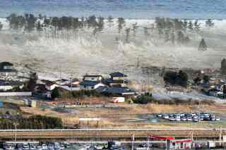 Waves of tsunami hit residences after a powerful earthquake in Natori, Miyagi prefecture (state), Japan, Friday, March 11, 2011. The largest earthquake in Japan's recorded history slammed the eastern coast Friday. (AP Photo/Kyodo News)