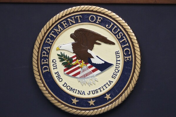 The Department of Justice seal is seen during a news conference Thursday, Dec. 5, 2024, in Memphis, Tenn. (AP Photo/George Walker IV, File)