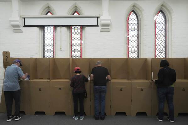 People cast there ballots at a polling place as early voting begins in Sydney, Tuesday, April 22, 2025, for a national election to be held on May 3. (AP Photo/Mark Baker)