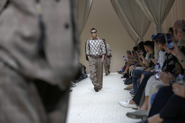 A model wears a creation as part of the men's Emporio Armani Spring-Summer 2026 collection, that was presented in Milan, Italy, Saturday, June 21, 2025. (AP Photo/Luca Bruno)
