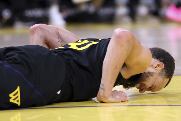 Butler scores 18, but Curry injured in Warriors 117-114 win over Raptors |  AP News
