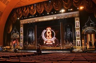 FILE - Workers prepare for the 73rd annual Tony Awards in New York on June 9, 2019. Producers of the telecast announced Wednesday that the Tonys will be held Sept. 26 and will air on CBS as well as Paramount+. (Photo by Charles Sykes/Invision/AP, File)