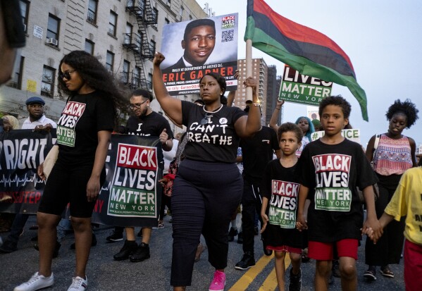 FILE - Activists with Black Lives Matter protest in the Harlem neighborhood of New York, Tuesday, July 16, 2019, in the wake of a decision by federal prosecutors who declined to bring civil rights charges against New York City police Officer Daniel Pantaleo, in the 2014 chokehold death of Eric Garner. The decision was made by Attorney General William Barr and announced one day before the five-year anniversary of his death, officials said. (AP Photo/Craig Ruttle, File)